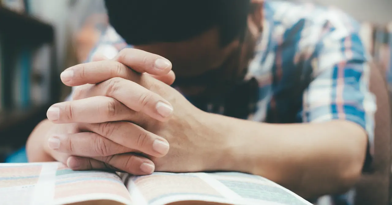 Christian praying with an open Bible, learning about the types, benefits, and daily practice of prayer to strengthen faith and spiritual growth.